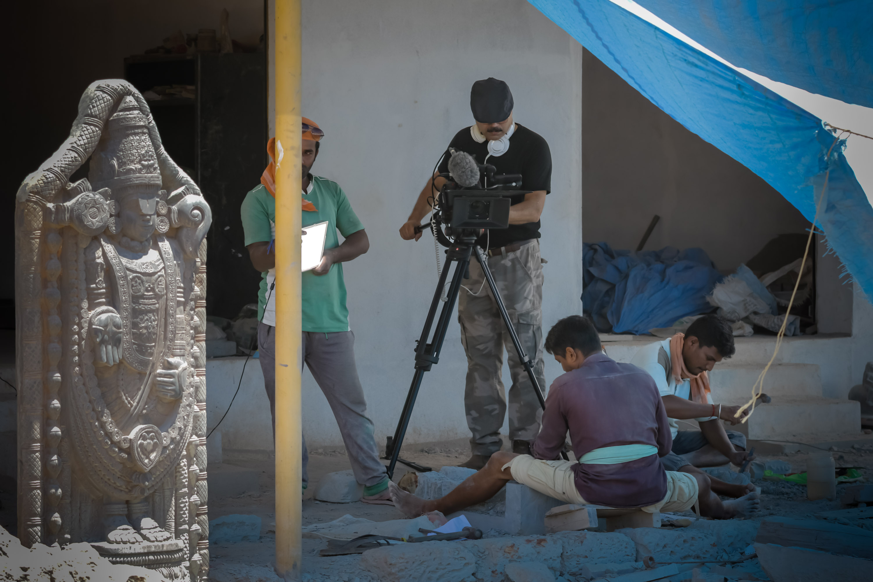 Filming local granite carvers at work